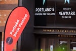 A red flag sign for the Portland Book Festival outside the Newmark Theatre in Portland.