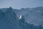 The sunset reflects off of an iceberg in Ilulissat.