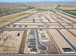 New homes are under construction in June at a housing development near Buckeye, Ariz. A growing number of local governments are considering limits on homebuilding in the face of floods, droughts and wildfires driven by climate change.