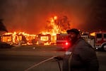 A resident of Altadena, Calif., tried to protect property during wildfires in January 2025. 
