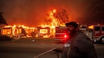 A resident of Altadena, Calif., tried to protect property during wildfires in January 2025.