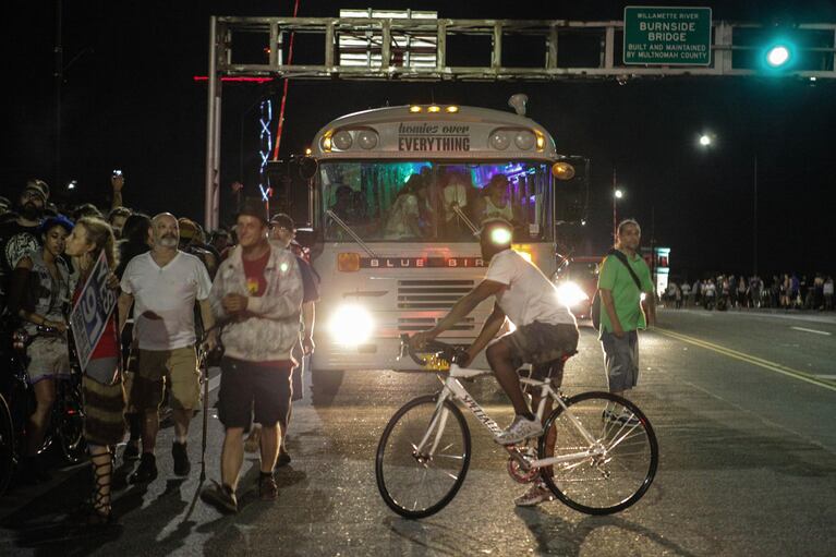 Participants gathered in the narrow pedestrian pathway, awaiting a marijuana seed giveaway and overflowed onto the road, causing traffic jams in both directions of the Burnside Bridge.
