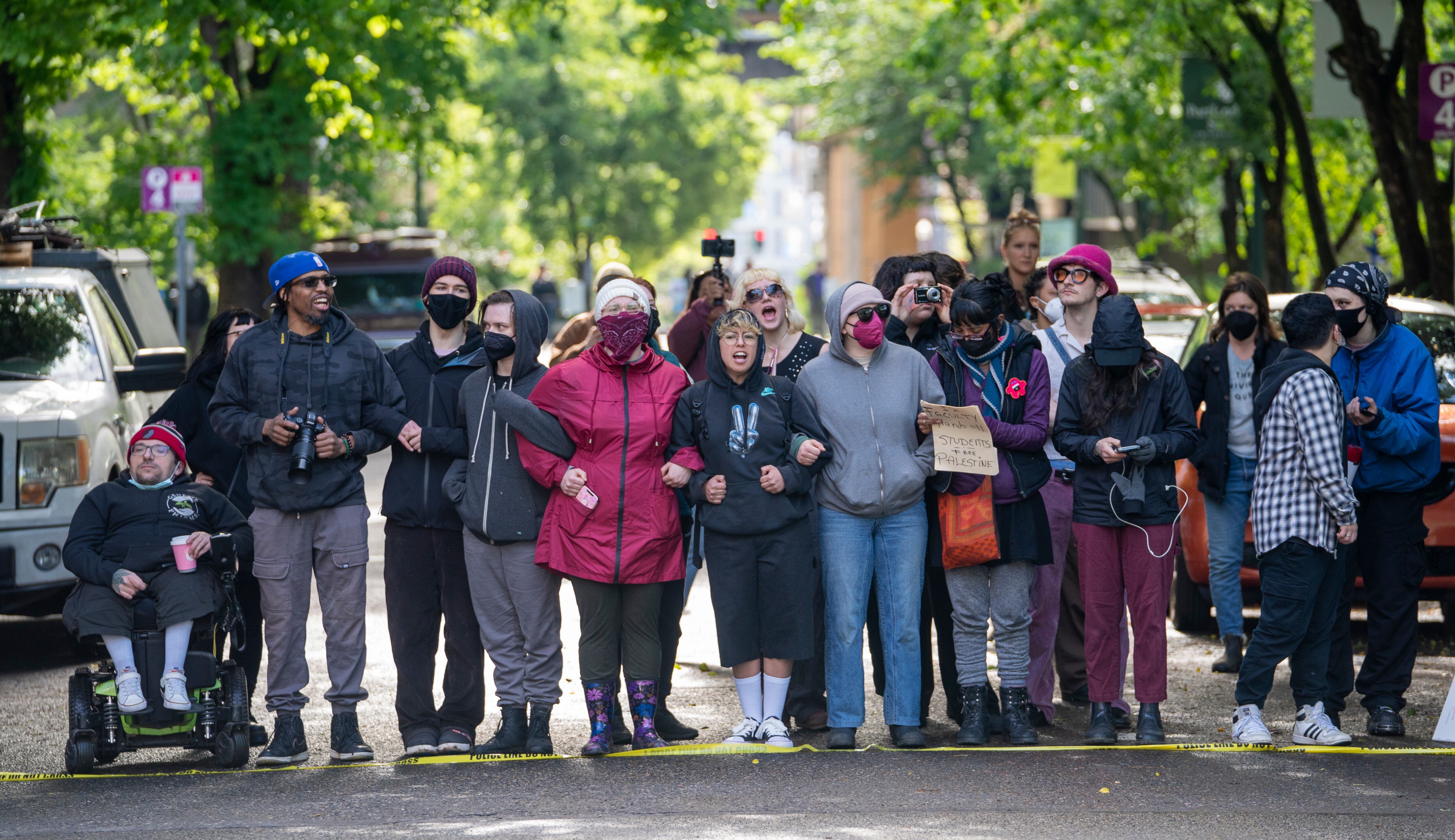 People chant as they watch law enforcement teams clear protesters from Portland State University’s Branford Price Millar Library, May 2, 2024. People protesting Israel's role in the war in Gaza had occupied the library since Monday evening.