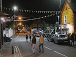 People walk across the main road during Lisdoonvarna Matchmaking Festival in Lisdoonvarna, Ireland, Sat., Sept. 27, 2025. The annual event, known as Europe’s biggest matchmaking festival, draws thousands seeking love, music and dancing. (Rob Stothard for NPR)