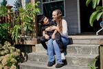 Marissa Williams and her son, Mason, sit on their porch.