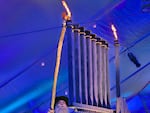 In this supplied photo, Rabbi Moshe Wilhelm, director of Chabad of Oregon, lights the Hanukkah menorah at Pioneer Courthouse Square in Portland, Ore., on Dec. 7, 2023.