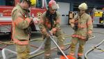 Firefighters with Portland Fire and Rescue demonstrate how they would apply fire retardant foam to contain and extinguish an oil train fire. 