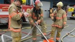 Firefighters with Portland Fire and Rescue demonstrate how they would apply fire retardant foam to contain and extinguish an oil train fire. 