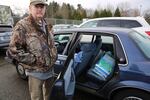 Matt Hall screens baggage for the TSA at the airport. He's been through a furlough before so he has savings to keep his family going for a short while. He picked up some free food and kitty litter from the Oregon Humane Society for his two cats.