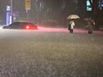 A vehicle is submerged in a flooded road in Seoul, Monday, Aug. 8, 2022.
