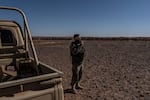 An FSA soldier stands few meters from the Jordanian border (After the piles of sand) outskirts of Rukban refugee camp. At the edge of the Jordanian border. Al Tanf, Syria. December 14, 2024.