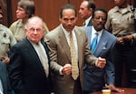 FILE - In this Oct. 3, 1995, file photo, O.J. Simpson reacts as he is found not guilty in the death of his ex-wife Nicole Brown Simpson and her friend Ron Goldman in Los Angeles. Defense attorneys F. Lee Bailey, left, and Johnnie L. Cochran Jr. stand with him. Cochran, Simpson's flamboyant lead attorney, died of brain cancer in 2005 at 68.