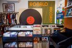 Binds of records with a large record poster on the wall.