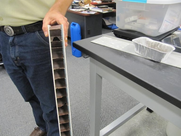 PSU engineering graduate student Seth Moody holding sample of Pacific Green Innovations’ building material.