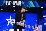 Elon Musk holds a chainsaw reading "Long live freedom, damn it" during the annual Conservative Political Action Conference (CPAC) at the Gaylord National Resort & Convention Center at National Harbor in Oxon Hill, Maryland, on February 20, 2025. The chainsaw was a present to Elon Musk from Argentina's President Javier Milei.