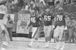 Members of the Cincinnati Bengals offensive line include wide receiver Steve Kreider (86), right guard Max Montoya (65) and left tackle Anthony Munoz (78) during an NFL game early in the football season of 1981. Location unknown.