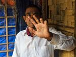 Badi Alom, age 62, says his fingers were cut after he was detained by the rebel Arakan Army when he went to a bazaar to buy fish for his family. He and his family now live in the Rohingya refugee settlement in Bangladesh.