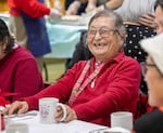 Frances Sumida Palk laughs as she talks with fellow guests during lunch.