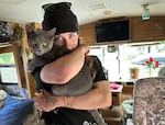 Kaylee, 23, spent most of her life in the state's custody. She is pictured in 2025 with her cat, which she rescued, in an RV in Cottage Grove where she sometimes crashes on the couch.
