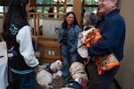 Northwest Battle Buddies graduate Rachel speaks with fellow graduate Mike and family members during the ceremony Vancouver, Wash., on Saturday, Nov. 21, 2025. The nonprofit matches veterans suffering from PTSD with service dogs during a five-week training course.