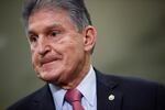 In this Feb. 5, 2020, file photo, Sen. Joe Manchin, D-W.Va., speaks with reporters on Capitol Hill in Washington. A bipartisan group of lawmakers, including Manchin, is putting pressure on congressional leaders to accept a split-the-difference solution to the months-long impasse on COVID-19 relief in a last-gasp effort to ship overdue help to a hurting nation before Congress adjourns for the holidays.