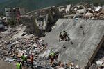 Mexican Army rescue workers search Sunday for people trapped in collapsed buildings after earthquakes struck La Guaira, Venezuela.