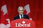Mark Carney speaks from a podium with the word "Liberal."