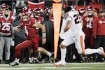 Washington State quarterback Zevi Eckhaus (4) carries the ball while pressured by Oregon State linebacker Nikko Taylor (25) during the second half of an NCAA college football game, Saturday, Nov. 29, 2025, in Pullman, Wash.