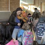 School counselor Claudia Brown plays the violin to welcome back students at Lent Elementary in Southeast Portland on Monday.