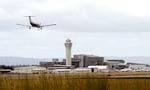 FILE: In this July 13, 2014, photo, a plane lands at Portland International Airport in Portland, Ore.