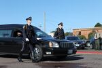 Law enforcement agents guide the hearse carrying slain Seaside Police Sgt. Jason Goodding.
