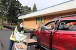 Third grade teacher Katherine Fitzgerald hands out distance learning tools and resources at Rock Creek Elementary School 's laptop giveaway on March 30, 2020.