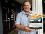 In this supplied photo, tribal elder David Lewis is shown with an advance copy of his book titled "Tribal Histories of the Willamette Valley." The book was released Nov. 14, 2023.