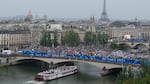 Athletes travel by boat along the Seine river during the opening ceremony of the 2024 Summer Olympics, in Paris, France, Friday, July 26, 2024.