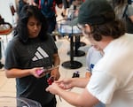 Garrett Hudson, right, gives a young attendee a new Beyblade, saying, “It’s incredible, it doesn’t matter who or what you are, you’re a blader,” at the final Beyblade tournament being held at the Lloyd Center shopping mall in Portland, Ore., on Aug 2, 2026. Future tournaments will be held at Gambit’s Games and BatCave Games after the Lloyd Center closes.