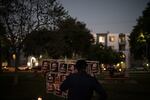 FILE - A man wipes his tears at a memorial featuring photos described as Iranian protesters killed in January, during a community gathering ahead of the Nowruz holiday in the Encino neighborhood of Los Angeles, March 17, 2026.