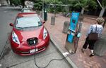 In this Aug. 18, 2011 file photo, A Nissan Leaf charges at a electric vehicle charging station in Portland, Ore. Oregon has signed on to the International Zero-Emission Vehicle Alliance, with a goal of having all new cars sold within its jurisdiction be emission-free by 2050. 