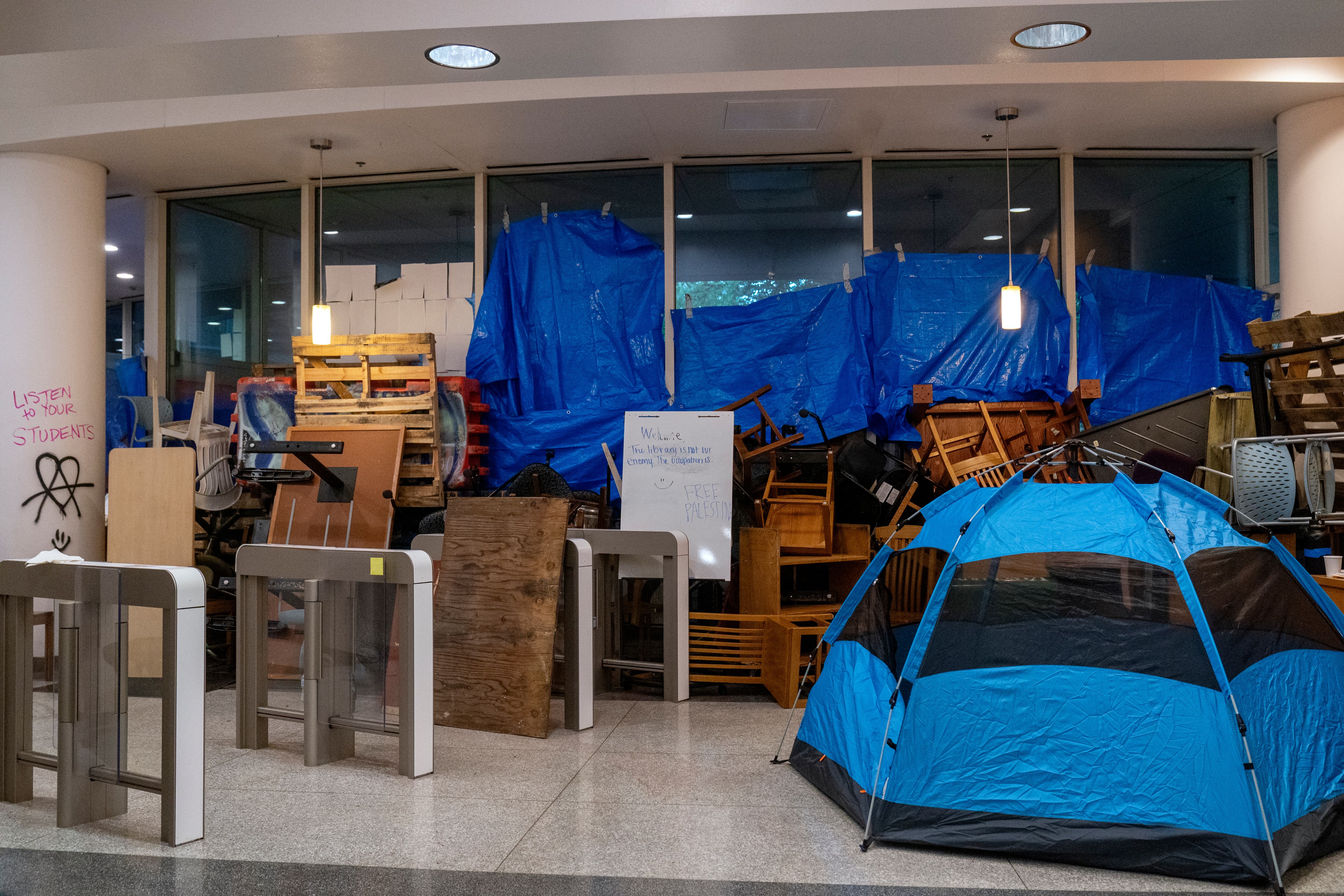 Tarps and blockades fortify the entrance to the occupied Branford Price Millar Library at Portland State University.