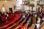 Worshippers spread out in the sanctuary of Struthers United Methodist Church during the Mother's Day Sunday service, the second to last service for the church before closing.