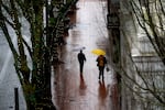 Pedestrians with umbrellas walk along SW Yamhill Street near SW 10th Avenue in Portland, Ore., Dec. 9, 2025. 