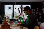 Victor "Marka27" Quiñonez, Mexican-born, Brooklyn-based visual artist holds the acrylic sculpture "Drippy Paleta Lime / Uva flavor" from the "I.C.E. Scream" Series at his studio in Ridgewood, Queens.