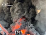 In this photo provided by the Ukrainian Emergency Service, firefighters put out a fire in a warehouse following a Russian drone attack near Kyiv, Ukraine on Saturday.