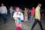 A woman rushes a child to the emergency ward after a fire broke out in a neonatal intensive care unit at Jhansi Medical College hospital in Jhansi, India, on Friday.