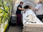 MRI technician Helen Cryan gets Retta Jacobi ready for her scan inside a mobile imaging semitrailer at Southwest Healthcare Services in Bowman, North Dakota, with the help of the truck’s driver, Kevin Kraft, who also works as a medical assistant.