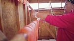 Fish-cutter and business owner Brigette McConville (Warm Springs, Wasco and Northern Paiute) prepares salmon the traditional wind-dried way, Sept. 18, 2021. The head and bones are removed from the meat, which is then sliced into strips, salted and hung to dry for several days. 