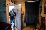 A man carries a 5 gallon water dug into his home.