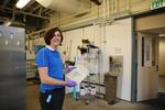 Angee Hunt, in the the surimi school industrial kitchen, holding a bag of noodles made almost entirely from surimi.