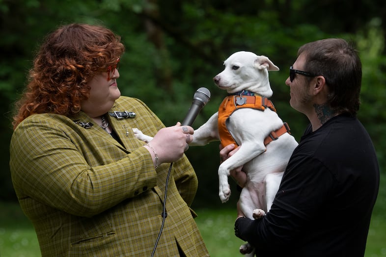Host Ally J. Ward, left, interviews Chad Walter, right, and dog Betty White.