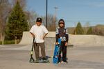 Mckie Suppah (left) and his friend Dwayne, both fifth graders at Warm Springs K-8 Academy, pose for their photo during their afternoon skating session on April 30, 2023.