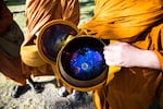 Ajahn Sudanto displays the inside of his alms bowl. He likens the interior to a starry night.